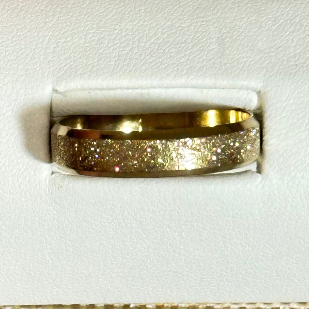 Gold tone band, Center has texture that gives flash, polished Borders - NWOT